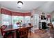 Bright dining area adjacent to the living room, featuring a fireplace and a large bay window at 127 Laurel Springs Dr, Mcdonough, GA 30253