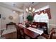 Elegant dining room with hardwood floors, chandelier, and ample natural light from a large window at 127 Laurel Springs Dr, Mcdonough, GA 30253