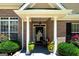 Welcoming front porch with decorative columns, potted plants, and cozy seating area at 127 Laurel Springs Dr, Mcdonough, GA 30253
