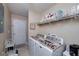 Functional laundry room with washer, dryer, and storage shelving for organization at 127 Laurel Springs Dr, Mcdonough, GA 30253