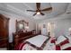 Cozy main bedroom with decorative tray ceiling, fan, and dark wood furniture at 127 Laurel Springs Dr, Mcdonough, GA 30253