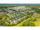 An overhead view of the townhouses, exhibiting vast residential areas, a pond, and a park at 1851 Grove Way, Hampton, GA 30228