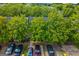A high-angle view of the townhouse complex, showcasing neat landscaping and ample parking spots for each residence at 1851 Grove Way, Hampton, GA 30228
