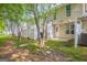 A view of the backyard, featuring a privacy fence and mature trees on a sunny day at 1851 Grove Way, Hampton, GA 30228