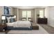 Comfortable bedroom with large windows, soft carpet, and stylish furniture at 1851 Grove Way, Hampton, GA 30228