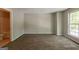 Bedroom featuring neutral paint, carpet floors, large window, and an ensuite bathroom at 1851 Grove Way, Hampton, GA 30228