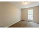 Bedroom featuring neutral paint, carpet floors, and a large window at 1851 Grove Way, Hampton, GA 30228