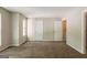 Spacious bedroom with neutral paint, carpet floors, and multiple closets at 1851 Grove Way, Hampton, GA 30228