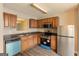 Well-equipped kitchen with stainless steel appliances, wood cabinets, and laminate flooring at 1851 Grove Way, Hampton, GA 30228