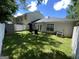 A charming backyard featuring a well-manicured lawn, a storage shed, and a classic white picket fence at 401 Bainbridge Dr, Mcdonough, GA 30253