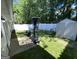 Private backyard with well-maintained lawn, white fence, and storage shed at 401 Bainbridge Dr, Mcdonough, GA 30253