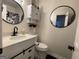 Charming bathroom with white vanity, a toilet, and black fixtures and accessories at 401 Bainbridge Dr, Mcdonough, GA 30253