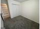 Simple bedroom with a double door closet, neutral walls, and carpeted floors at 401 Bainbridge Dr, Mcdonough, GA 30253