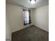 Cozy bedroom featuring neutral walls and a window with patterned curtains at 401 Bainbridge Dr, Mcdonough, GA 30253