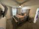 Bedroom featuring a wooden bed frame, ceiling fan, and carpeted floors at 401 Bainbridge Dr, Mcdonough, GA 30253