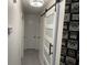 Hallway with modern light fixture and unique geometric accent wall at 401 Bainbridge Dr, Mcdonough, GA 30253