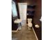 Modern bathroom featuring a pedestal sink, updated fixtures, and decorative black shelving for storage at 2884 Mountbery Dr, Snellville, GA 30039