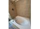 Inviting bathroom features a luxurious white soaking tub with whirlpool jets and tile surround at 2884 Mountbery Dr, Snellville, GA 30039
