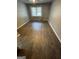 Sunlit bedroom features neutral walls, ceiling fan and wood-look floors, creating a serene atmosphere at 2884 Mountbery Dr, Snellville, GA 30039