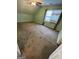 Bedroom with wall-to-wall carpeting, a window and a ceiling fan, creating a welcoming atmosphere at 2884 Mountbery Dr, Snellville, GA 30039