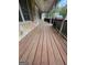 Spacious wooden front porch with white railings and ceiling fans at 2884 Mountbery Dr, Snellville, GA 30039