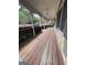 A view of the long wooden porch with white columns and railings, perfect for relaxing at 2884 Mountbery Dr, Snellville, GA 30039