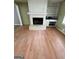 Spacious living room featuring a fireplace, built-in shelving, and hardwood flooring at 2884 Mountbery Dr, Snellville, GA 30039
