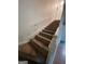 Carpeted staircase with white railing leading to the upper level of the home at 2884 Mountbery Dr, Snellville, GA 30039