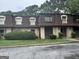 Modest townhouse with brown shingles and manicured shrubbery at 2968 Par Lorraine, Lithonia, GA 30038