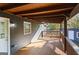 Expansive covered back porch offers ample room for relaxing with a ceiling fan at 389 Oglesby Bridge, Conyers, GA 30094