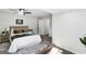 This staged bedroom features a plush bed, stylish decor, and a modern ceiling fan at 389 Oglesby Bridge, Conyers, GA 30094