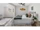 Modern bedroom featuring neutral paint, ceiling fan, and gold decorative wall art at 389 Oglesby Bridge, Conyers, GA 30094