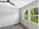 Bright bedroom offers soft carpet, a ceiling fan, and a window bringing natural light at 389 Oglesby Bridge, Conyers, GA 30094