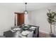 Modern dining room featuring sleek, dark wood table and minimalist light fixture at 389 Oglesby Bridge, Conyers, GA 30094