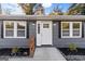 Charming front entrance with freshly painted exterior and well-maintained landscaping at 389 Oglesby Bridge, Conyers, GA 30094