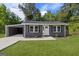Charming single-story home boasts a well-maintained lawn, attached carport, and inviting front entrance at 389 Oglesby Bridge, Conyers, GA 30094