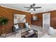 Cozy living room featuring wood paneled accent walls and comfortable seating at 389 Oglesby Bridge, Conyers, GA 30094