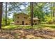 Backyard featuring a grassy area and mature trees at 6500 Wild Turkey Trl, Riverdale, GA 30296