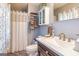Bathroom featuring a shower with curtain, toilet, sink and cabinet at 6500 Wild Turkey Trl, Riverdale, GA 30296