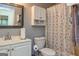 Bathroom featuring a shower with curtain, toilet, sink and vanity at 6500 Wild Turkey Trl, Riverdale, GA 30296