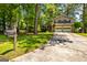 Charming two-story home with a two-car garage and long driveway, surrounded by lush greenery and mature trees at 6500 Wild Turkey Trl, Riverdale, GA 30296