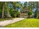 Charming two-story home with a two-car garage surrounded by lush greenery and mature trees at 6500 Wild Turkey Trl, Riverdale, GA 30296