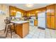 Functional kitchen with wooden cabinets, white appliances, and a convenient breakfast bar area at 6500 Wild Turkey Trl, Riverdale, GA 30296
