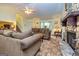 Inviting living room with a stone fireplace, cozy seating, and a view of the staircase at 6500 Wild Turkey Trl, Riverdale, GA 30296
