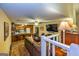 Open-concept living room with cozy seating, a built-in entertainment center, and adjacent breakfast bar at 6500 Wild Turkey Trl, Riverdale, GA 30296