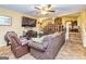 Spacious living room with cozy seating, a built-in entertainment center, and view of the upstairs living area at 6500 Wild Turkey Trl, Riverdale, GA 30296