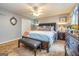This bedroom features a large bed with nightstands, ceiling fan, and carpet flooring at 6500 Wild Turkey Trl, Riverdale, GA 30296