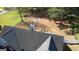 Overhead view of the home highlighting the backyard with a fire pit and manicured lawn near a treeline at 50 Berkshire Pass, Covington, GA 30016