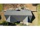Aerial view showcasing the home's roof and backyard with patio furniture and meticulously maintained landscaping at 50 Berkshire Pass, Covington, GA 30016