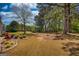 Expansive backyard featuring mature trees and an outdoor living space perfect for entertaining and relaxation at 50 Berkshire Pass, Covington, GA 30016